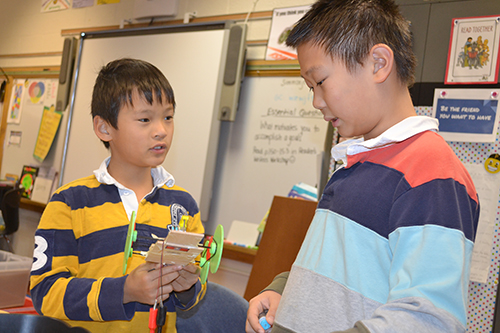 Two Dr. Howard students discuss their solar car design.